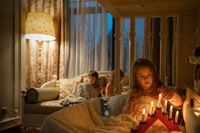 People in illuminated room at home