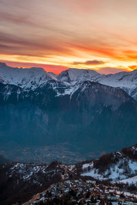 Scenic view of snowcapped mountains against sky during sunset