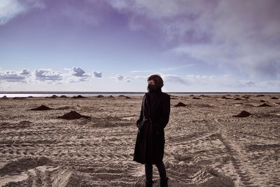 Man standing on beach against sky
