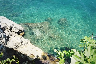 High angle view of rocks by sea