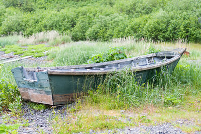 Abandoned boats on grassy field