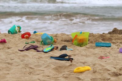 Buckets and flip-flops at beach