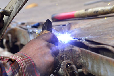 Midsection of man welding in workshop