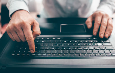 Midsection of man using laptop