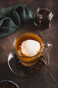 Affogato espresso coffee with vanilla ice cream in a cup on the table vertical view