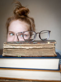 Portrait of young woman writing in book on table