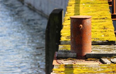 Close-up of rusty metal railing against wall