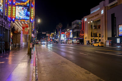Hollywood boulevard street amidst illuminated theatres and restaurants