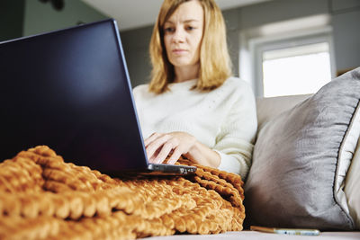 Woman working at home with laptop