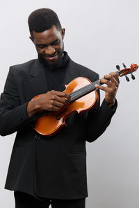 Man playing violin against white background