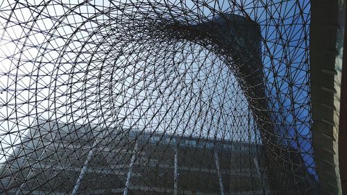 Low angle view of building seen through chainlink fence