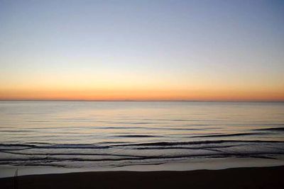 Scenic view of beach against sky during sunset