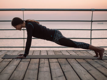 Reflection of woman on railing against footpath