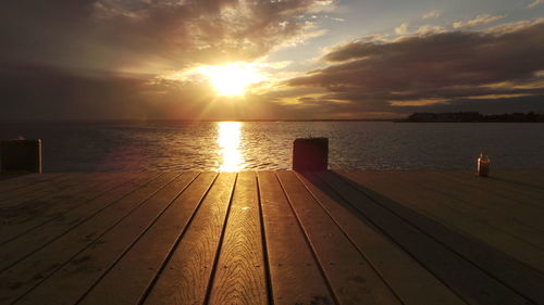 Pier on sea at sunset