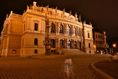 Illuminated building in city at night