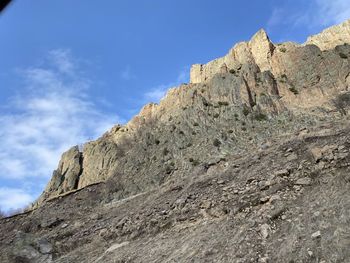 Low angle view of rock formations against sky