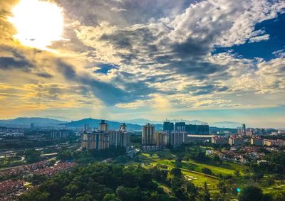 High angle view of cityscape against cloudy sky