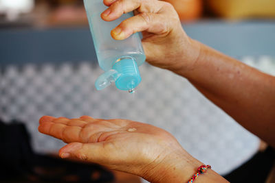 Close-up of hand holding bottle