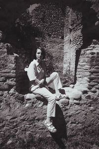 Young woman sitting on rock