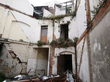 Abandoned building by residential buildings