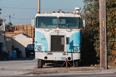 Abandoned truck on road against sky