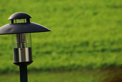Close-up of electric lamp on field