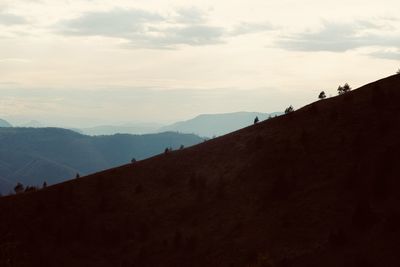 Scenic view of silhouette mountains against sky during sunset