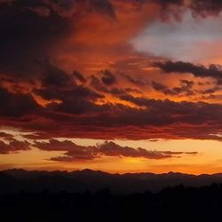 Scenic view of mountains against sky at sunset