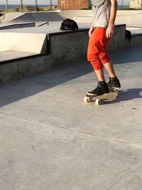 Low section of man skateboarding on skateboard