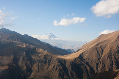 Scenic view of mountains against cloudy sky