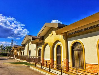 Houses in city against blue sky