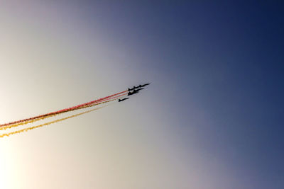 Low angle view of airplane flying against clear sky