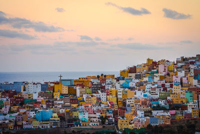 Buildings against sky during sunset in city