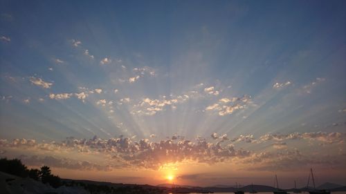 Sunlight streaming through clouds during sunset