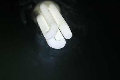 High angle view of light bulb against black background