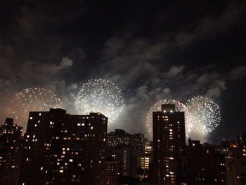 Low angle view of firework display at night