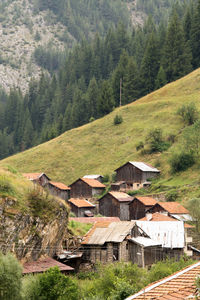 High angle view of houses amidst trees and buildings