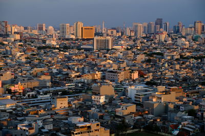 High angle view of buildings in city against clear sky