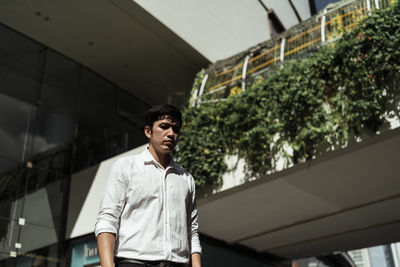 Low angle view of businessman standing in city