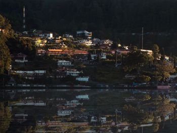 Illuminated cityscape against sky at night