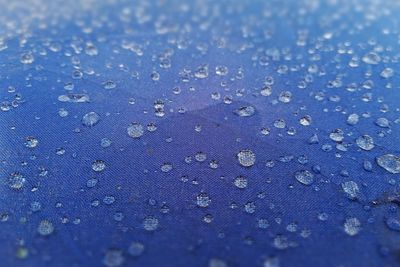 Full frame shot of raindrops on wet glass