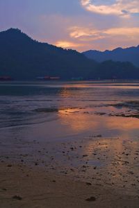 Scenic view of beach against sky during sunset