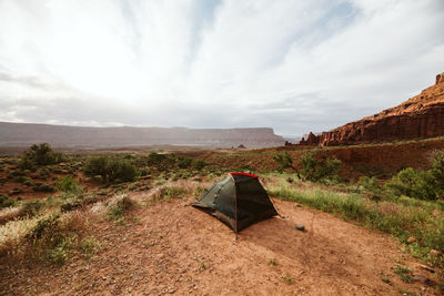 Black tent setup near moab utah under red sandstone buttes