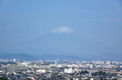 Aerial view of city and snow-capped mountain