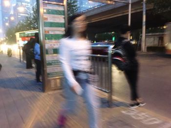 Blurred motion of people walking on street at night