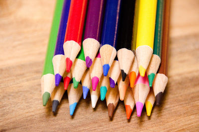Close-up of colored pencils arranged on table