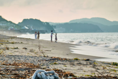 People on beach against sky