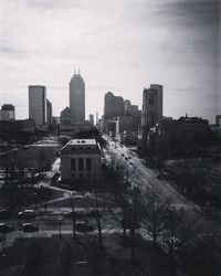 View of cityscape against cloudy sky