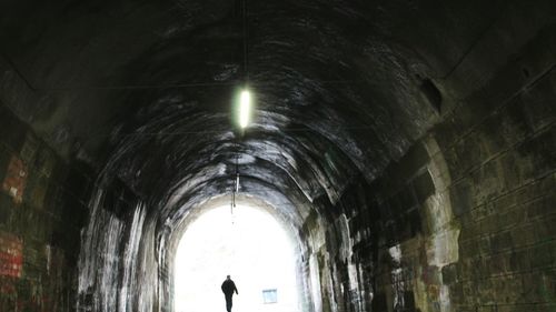 Silhouette of illuminated tunnel