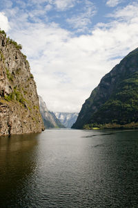 Scenic view of sea and mountains against sky